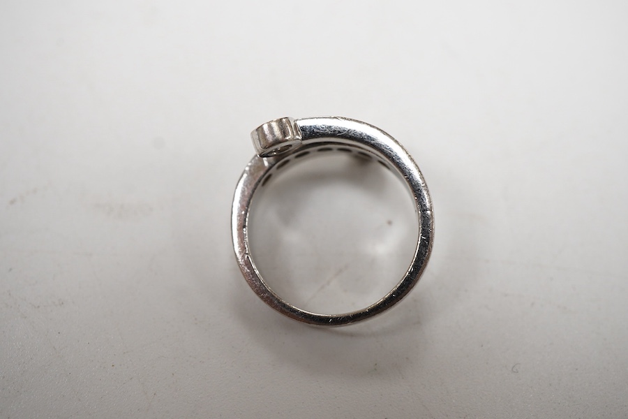 A recent 14k white metal and diamond ring, the ring head designed as three bands, central row of seven graduated diamonds, with two outer collet set diamonds, size G/H.